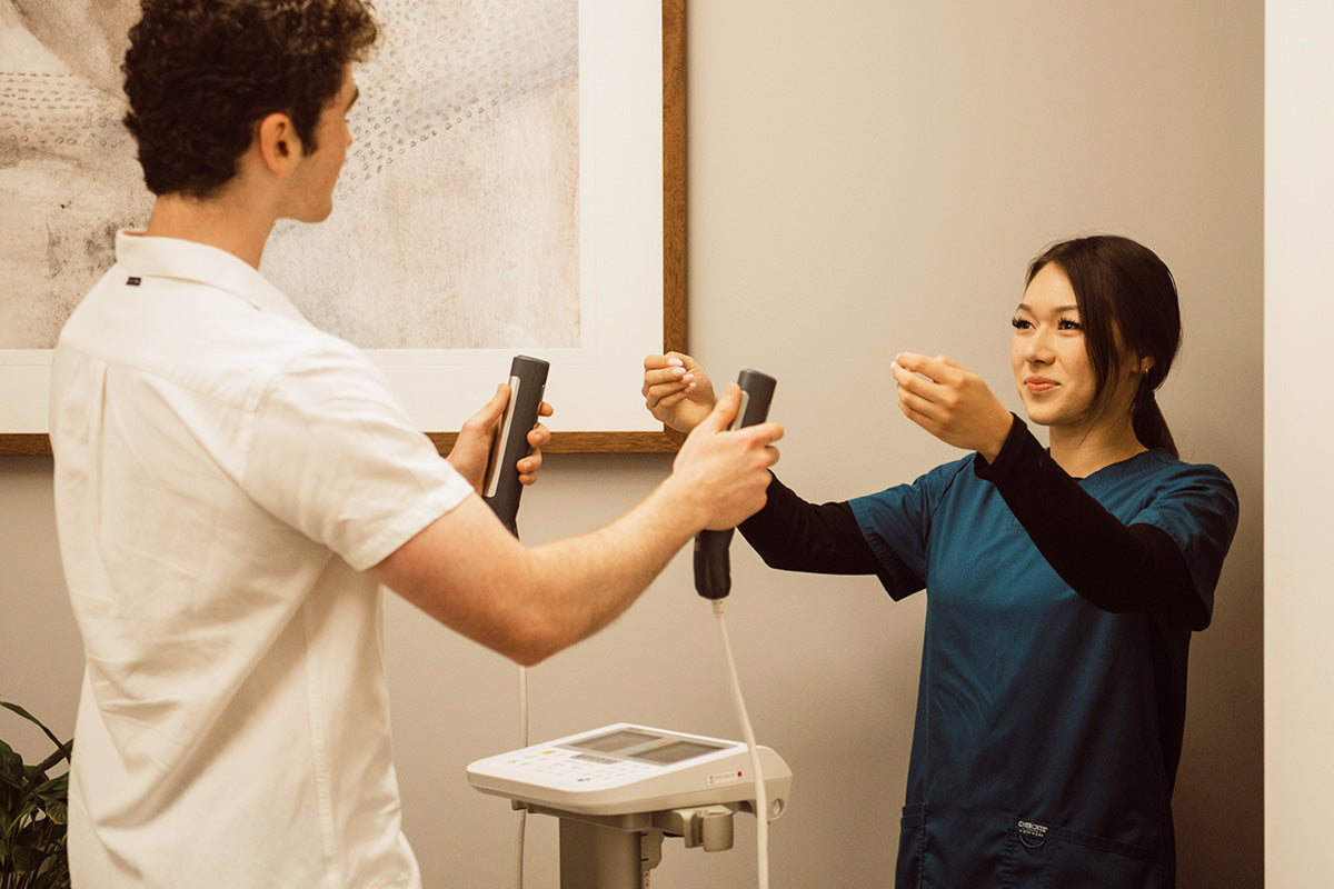 Nurse assisting a patient with biometric scales.
